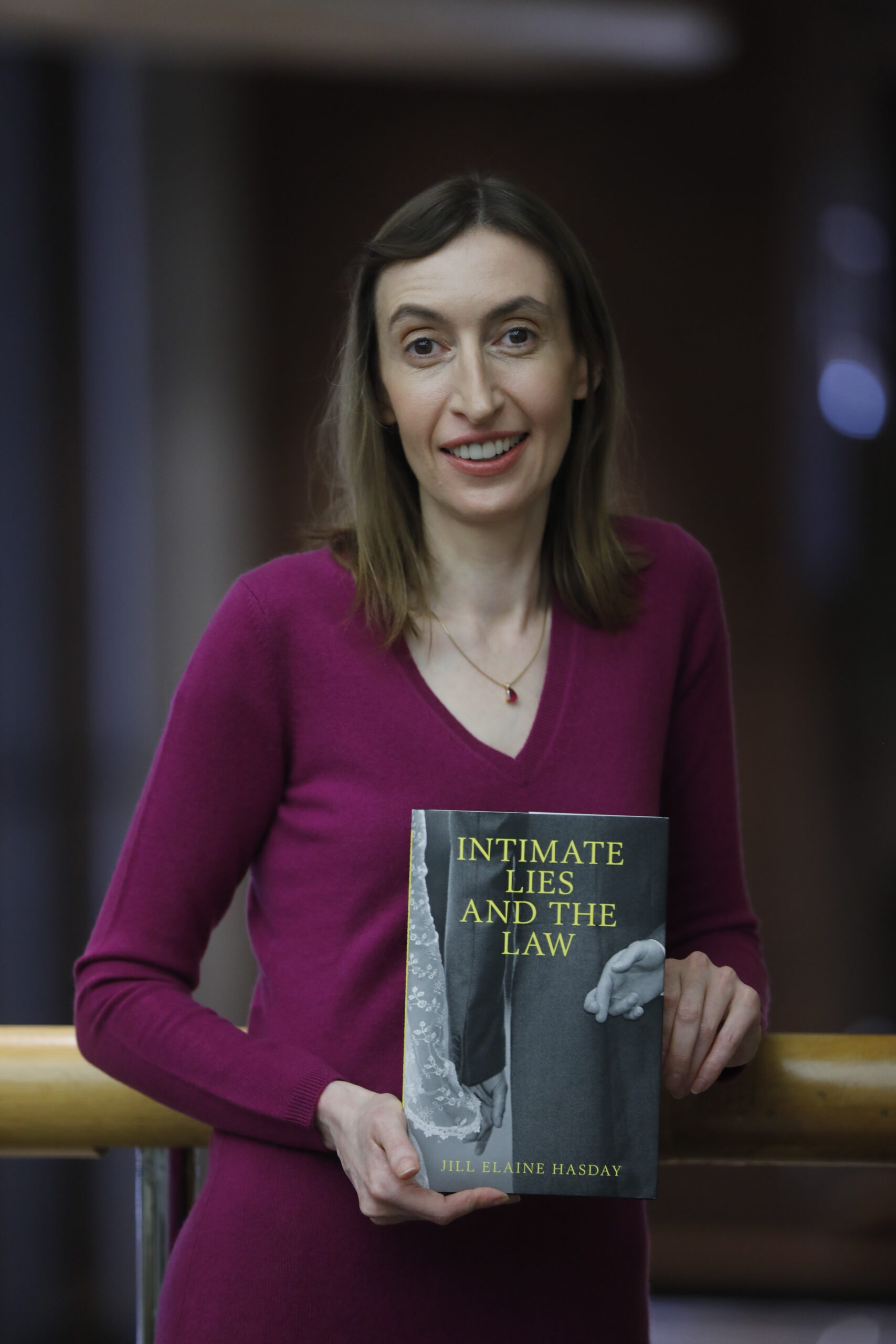 Professor Hasday holding a copy of her book "Intimate Lies and the Law"