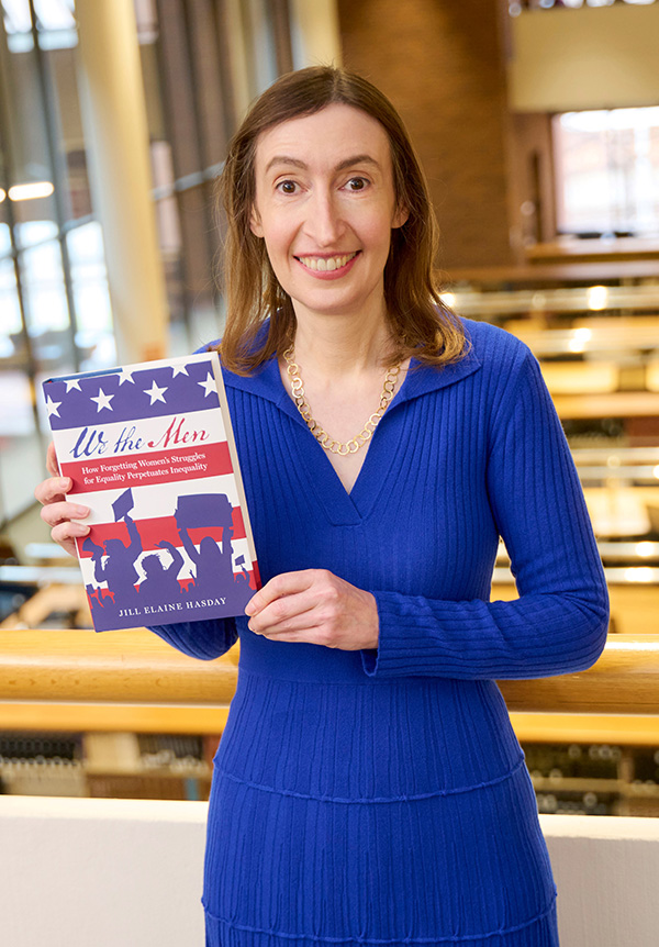 Professor Jill Hasday holding a copy of her new book "We the Men"